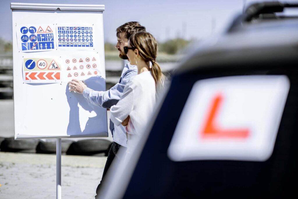 driver-instructor-with-student-on-the-training-gro-ENAUHMC.jpg